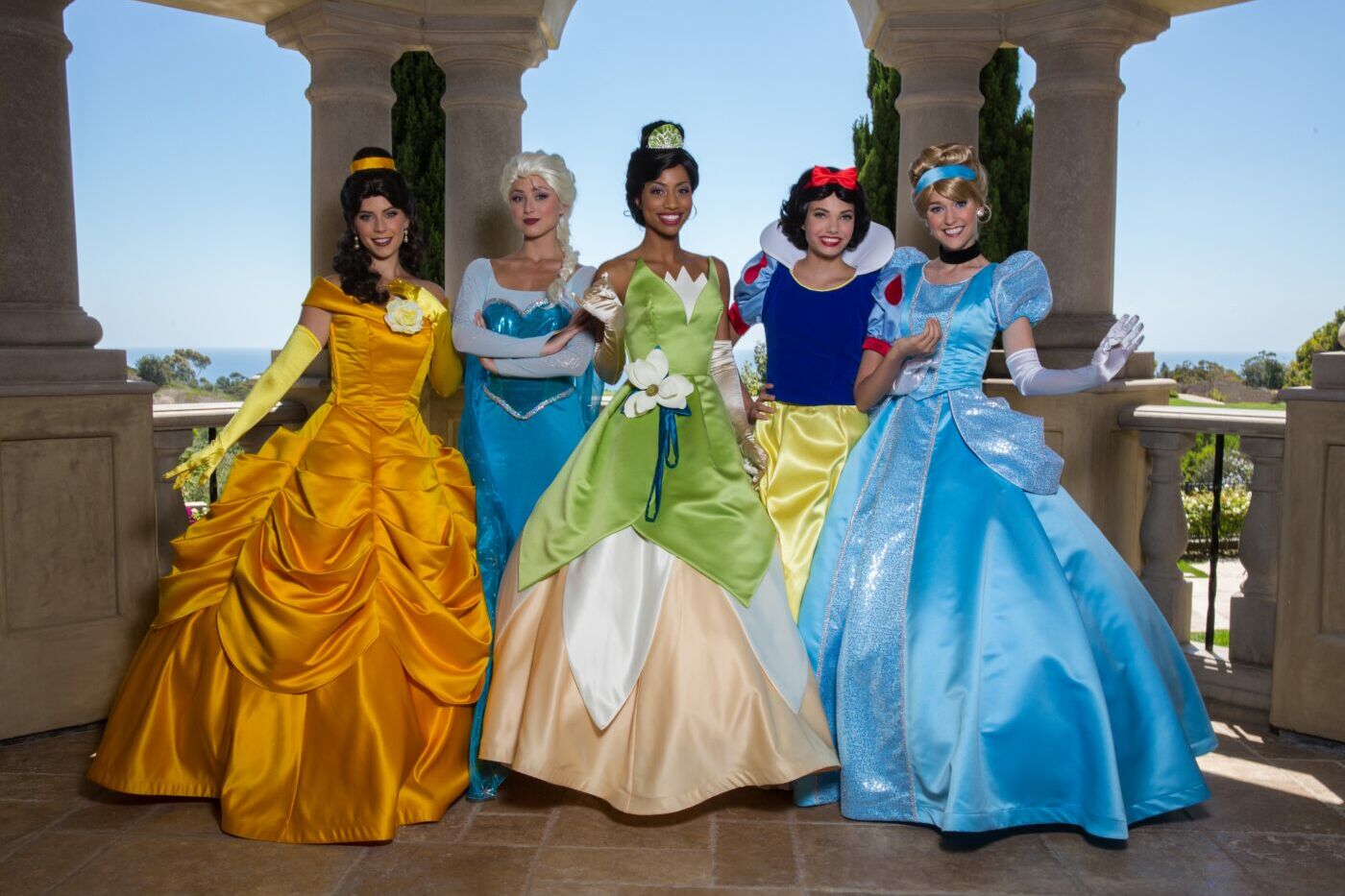 A princess-themed birthday party table with pink and gold decorations.